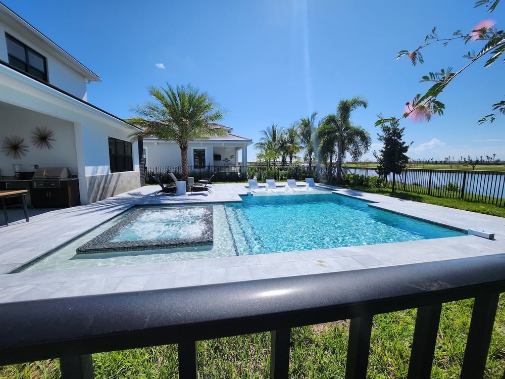 Model home pool with travertine coping and spa