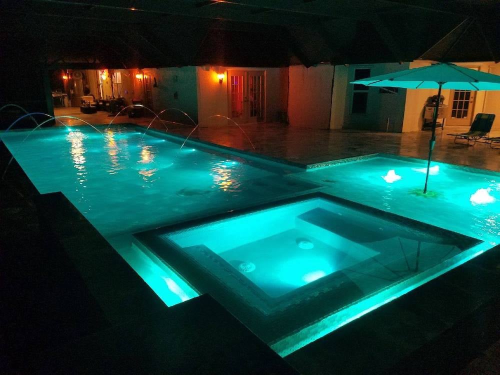 Pool with LED lighting reflecting off the water at night